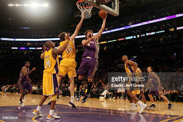 Center Robin Lopez of the Phoenix Suns goes up for a shot as Pau Gasol of the Los Angeles Lakers defends in Game One of the Western Conference Finals...