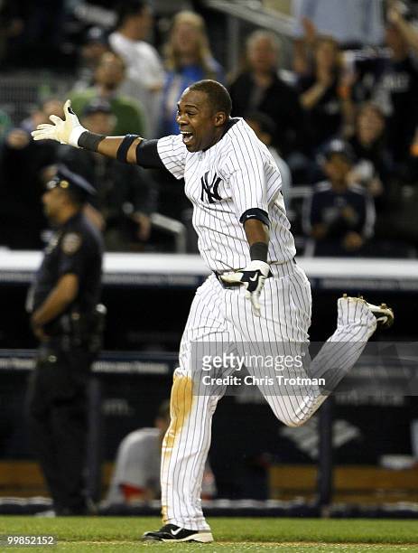 Marcus Thames of the New York Yankees celebrates his two-run walk off home run in the ninth inning to beat the Boston Red Sox on May 17, 2010 at...