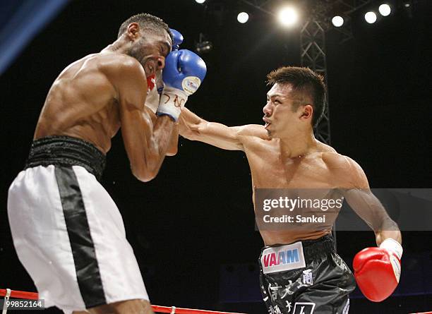 Champion Takashi Uchiyama of Japan hits his right on challenger Angel Granados of Venezuela during the WBA Super Featherweight Title Fight at Saitama...