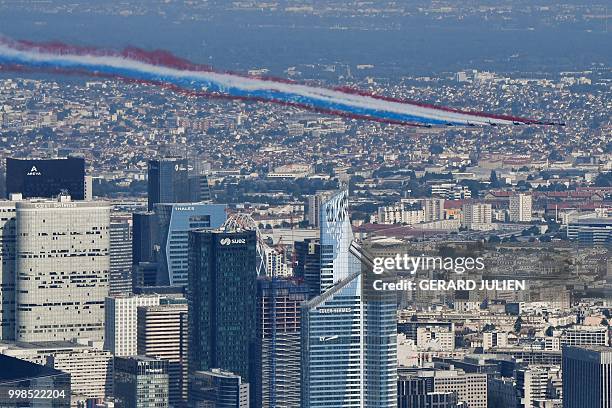 An aerial view of the Patrouille de France Alpha Jet aircrafts flying over the city during the annual Bastille Day military parade on the...