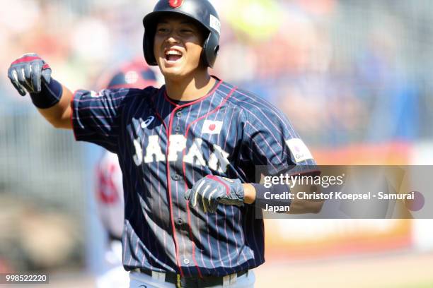 Toshiya Sato of Japan celebrates scoring a point during the Haarlem Baseball Week game between Chinese Taipei and Japan at the Pim Mulier...