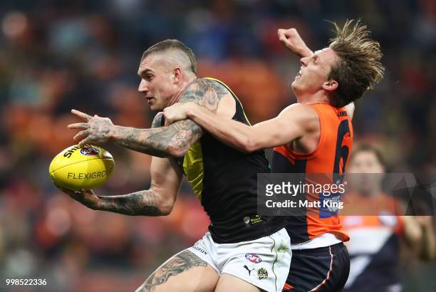 Dustin Martin of the Tigers is challenged by Lachie Whitfield of the Giants during the round 17 AFL match between the Greater Western Sydney Giants...