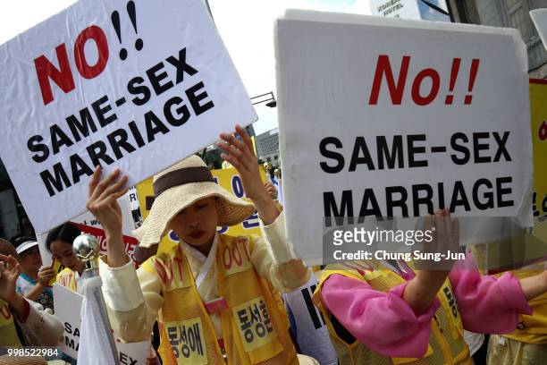 Anti same-sex marriage activists attend the rally next to the Korea Queer Culture Festival 2018 in front of City hall on July 14, 2018 in Seoul,...