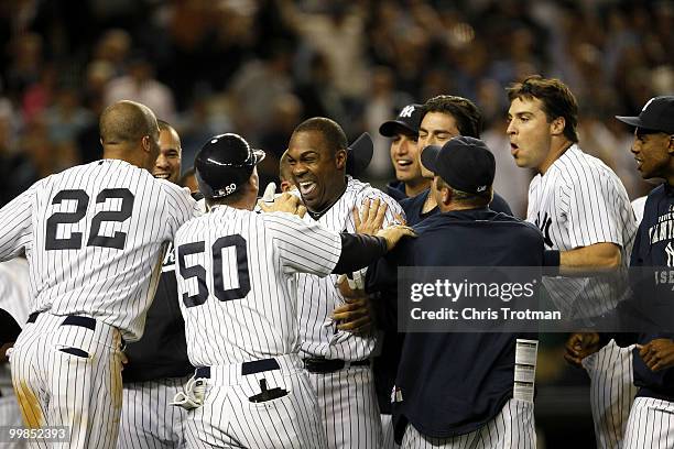 Marcus Thames of the New York Yankees is congratulated by his teammates following his two-run walk off in the ninth inning to beat the Boston Red Sox...