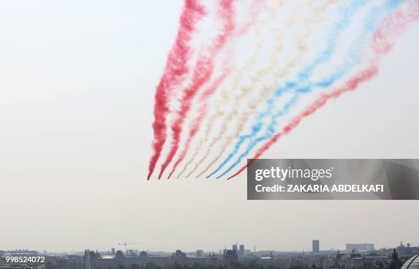 The Patrouille de France Alpha Jet perform at the start of the annual Bastille Day military parade over the Champs-Elysees avenue in Paris on July...