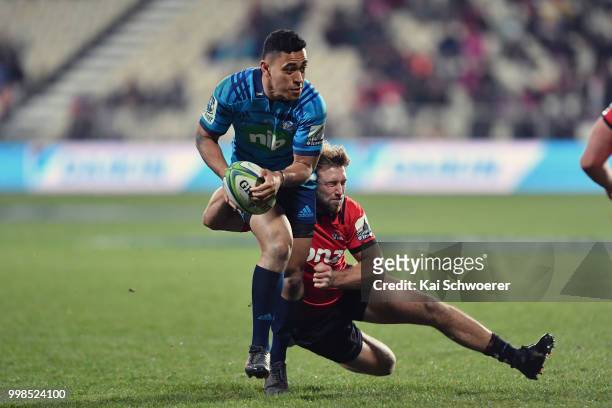 Stephen Perofeta of the Blues is tackled by Braydon Ennor of the Crusaders during the round 19 Super Rugby match between the Crusaders and the Blues...