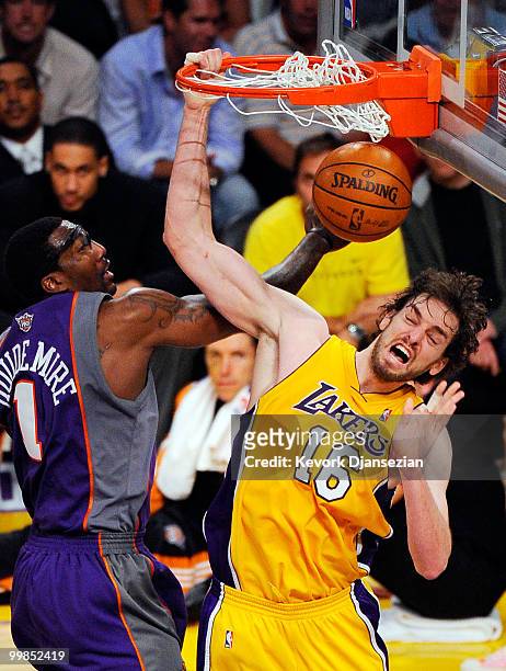 Pau Gasol of the Los Angeles Lakers dunks the ball against Amar'e Stoudemire of the Phoenix Suns during the fourth quarter in Game One of the Western...