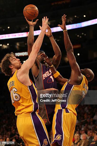Forward Amar'e Stoudemire of the Phoenix Suns goes up for a shot against Pau Gasol and Lamar Odom of the Los Angeles Lakers in Game One of the...
