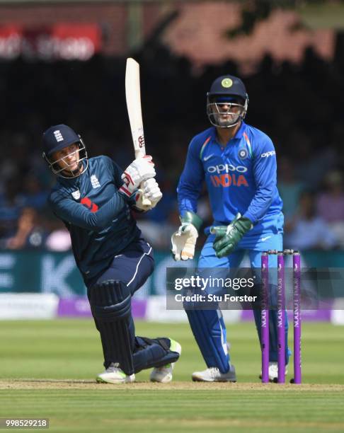 England batsman Joe Root hits out watched by MS Dhoni during the 2nd ODI Royal London One Day International match between England and India at Lord's...