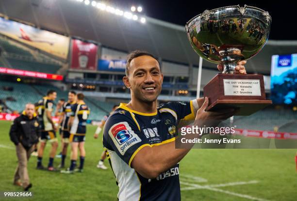 Captain Christian Lealiifano of the Brumbies holds up the Dan Vicerman cup after winning the round 19 Super Rugby match between the Waratahs and the...