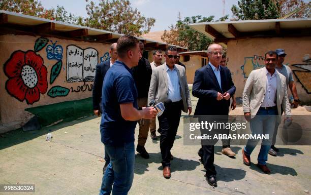 Palestinian Prime Minister Rami Hamdallah visits the Bedouin village of Khan al-Ahmar, in the occupied West Bank on July 14, 2018. - Israel's supreme...