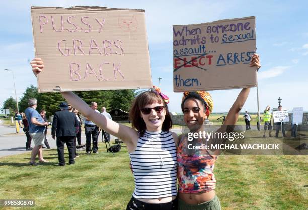 Protestors against the UK visit of US President Donald Trump hold placards outside his golf course, Trump International Golf Links near Aberdeen,...