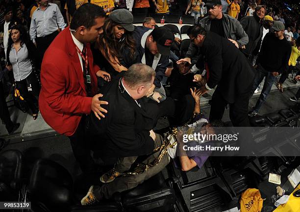 Actor David Arquette is knocked to the floor at the end of game between the Los Angeles Lakers and the Phoenix Suns in Game One of the Western...