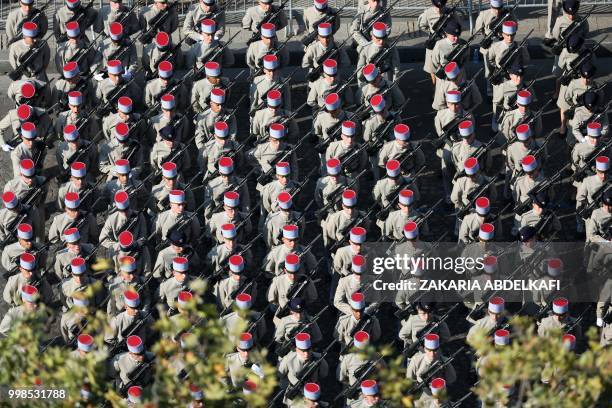 French soldiers of 2nd Regiment de Dragons stand in formation during the annual Bastille Day military parade on the Champs-Elysees avenue in Paris on...