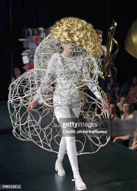 July 2018, Germany, Halle/Saale: Models present fashion pieces under the motto "Dance Hunting Wedding. Gustav Klimt and his kitties" by fashion...