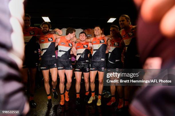 Brent Daniels of the Giants celebrates victory with team mates during the round 17 AFL match between the Greater Western Sydney Giants and the...