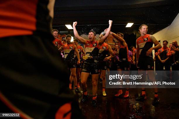 Brent Daniels of the Giants celebrates victory with team mates during the round 17 AFL match between the Greater Western Sydney Giants and the...