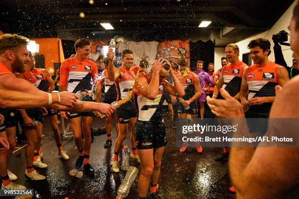 Brent Daniels of the Giants celebrates victory with team mates during the round 17 AFL match between the Greater Western Sydney Giants and the...