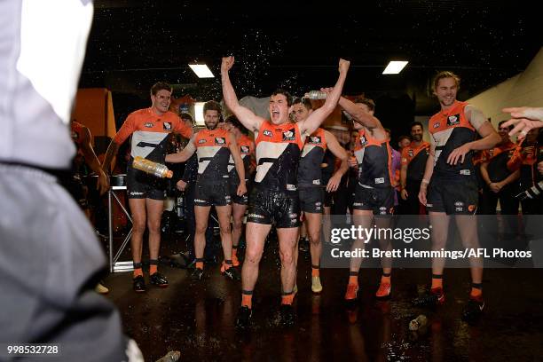 Brent Daniels of the Giants celebrates victory with team mates during the round 17 AFL match between the Greater Western Sydney Giants and the...