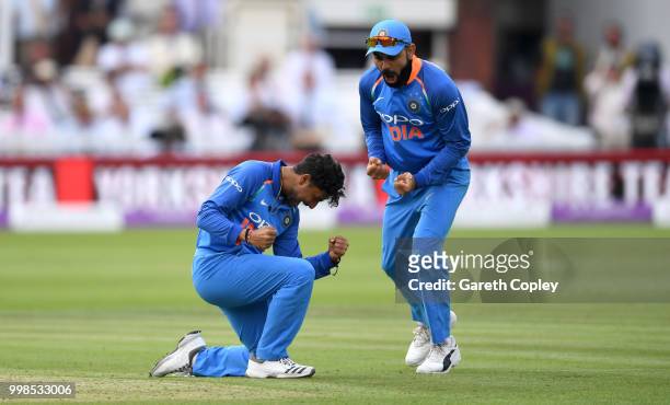 Kuldeep Yadav of India celebrates with captain Virat Kohli after dismissing England captain Eoin Morgan during the 2nd ODI Royal London One-Day match...