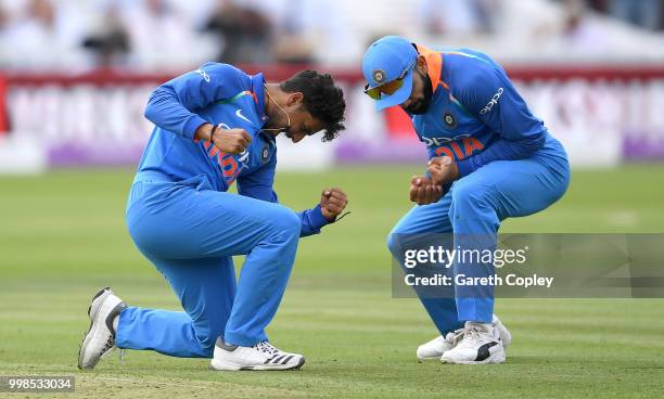 Kuldeep Yadav of India celebrates with captain Virat Kohli after dismissing England captain Eoin Morgan during the 2nd ODI Royal London One-Day match...