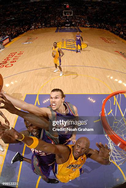 Lamar Odom of the Los Angeles Lakers reaches for the ball against Jason Richardson and Louis Amundson of the Phoenix Suns in Game One of the Western...