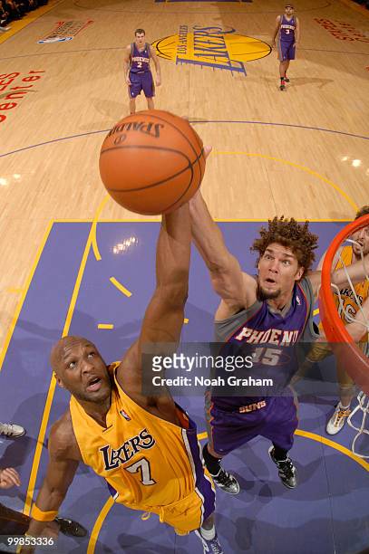 Lamar Odom of the Los Angeles Lakers and Robin Lopez of the Phoenix Suns reach for a rebound in Game One of the Western Conference Finals during the...