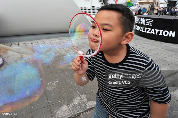 Little boy blows a big bubble outside the Czech Pavilion during the 'Czech Pavilion Day' on May 17, 2010 at the Expo Garden in Shanghai of China....