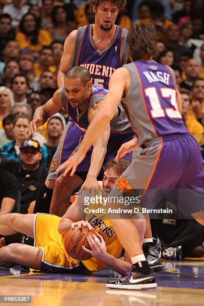 Pau Gasol of the Los Angeles Lakers handles the ball on the floor against Grant Hill and Steve Nash of the Phoenix Suns in Game One of the Western...