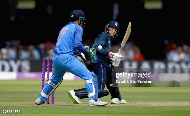 England batsman Joe Root flicks a ball to the boundary watched by MS Dhoni during the 2nd ODI Royal London One Day International match between...