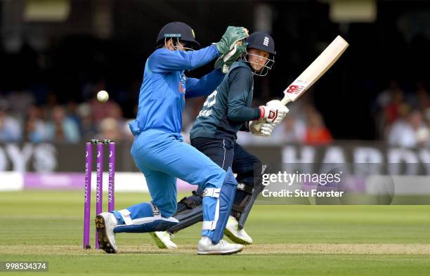 England batsman Joe Root flicks a ball to the boundary watched by MS Dhoni during the 2nd ODI Royal London One Day International match between...