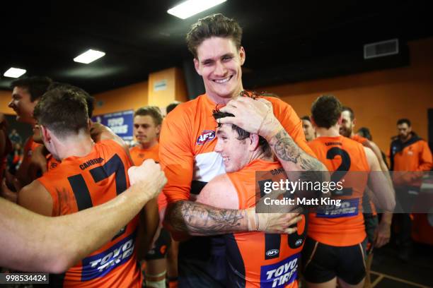 Rory Lobb and Brent Daniels of the Giants celebrate victory after the round 17 AFL match between the Greater Western Sydney Giants and the Richmond...