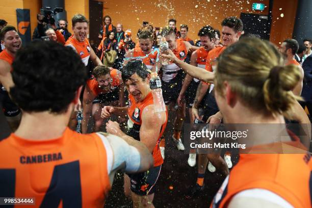 Brent Daniels of the Giants and team mates celebrate victory after the round 17 AFL match between the Greater Western Sydney Giants and the Richmond...