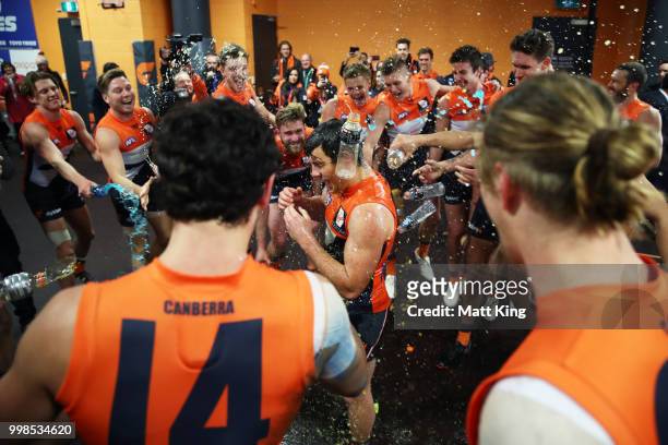 Brent Daniels of the Giants and team mates celebrate victory after the round 17 AFL match between the Greater Western Sydney Giants and the Richmond...