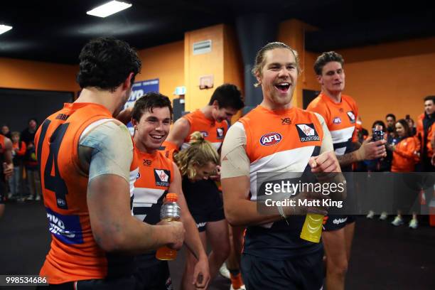 Brent Daniels and Harry Himmelberg of the Giants celebrate victory after the round 17 AFL match between the Greater Western Sydney Giants and the...