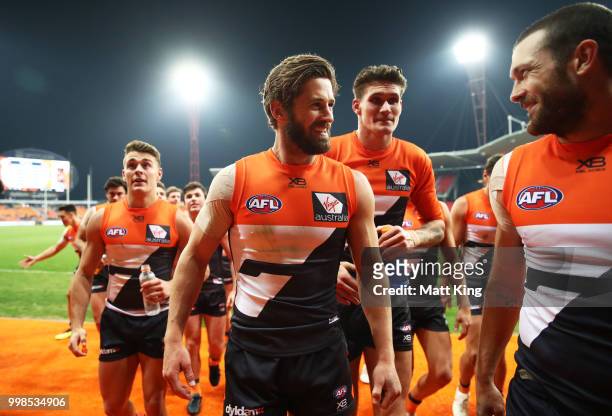 Callan Ward of the Giants and team mates celebrate victory after the round 17 AFL match between the Greater Western Sydney Giants and the Richmond...