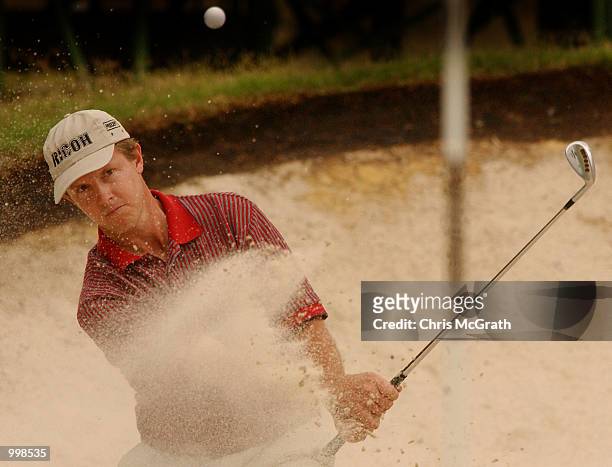 Scott Laycock of Australia chips out of the bunker on the 17th hole during the second round of the Holden Australian Open Golf Tournament held at The...