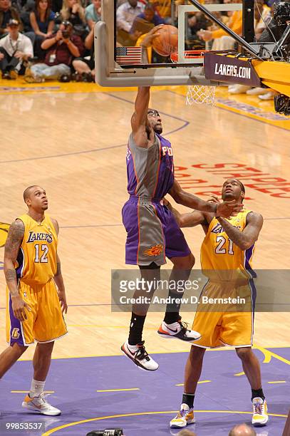 Amar'e Stoudemire of the Phoenix Suns rises for a dunk against Josh Powell of the Los Angeles Lakers in Game One of the Western Conference Finals...