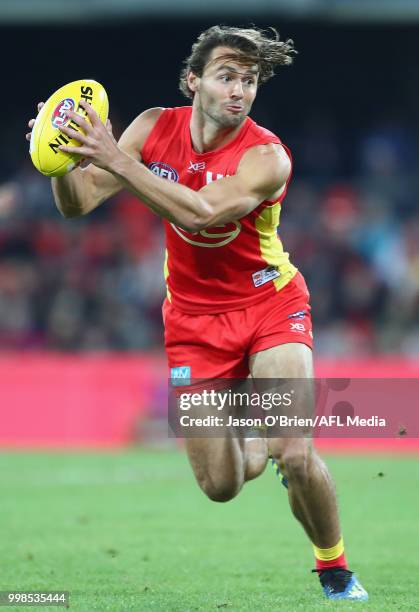 Lachie Weller of the Suns in action during the round 17 AFL match between the Gold Coast Suns and the Essendon Bombers at Metricon Stadium on July...