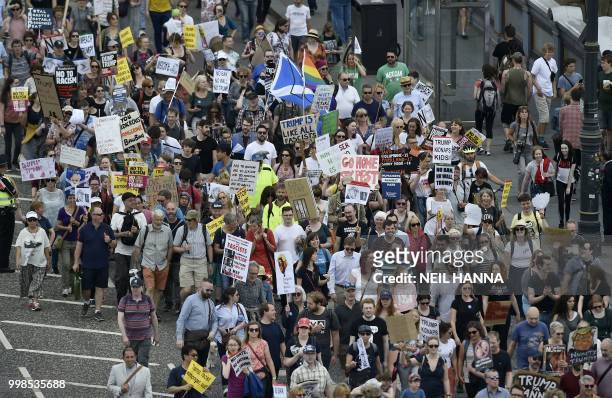 Protestors carry placards as they take part in the Scotland United Against Trump demonstration through the streets of Edinburgh, Scotland on July 14...