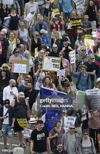 Protestors carry placards as they take part in the Scotland United Against Trump demonstration through the streets of Edinburgh, Scotland on July 14...