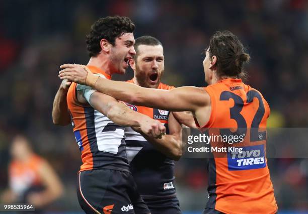 Tim Taranto, Sam Reid and Ryan Griffen of the Giants celebrate victory at fulltime during the round 17 AFL match between the Greater Western Sydney...