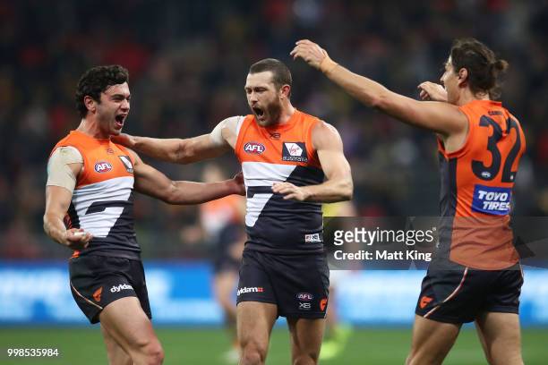 Tim Taranto, Sam Reid and Ryan Griffen of the Giants celebrate victory at fulltime during the round 17 AFL match between the Greater Western Sydney...