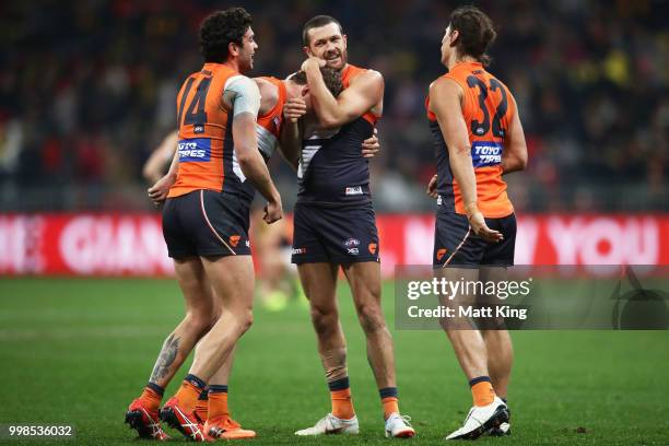 Tim Taranto, Sam Reid and Ryan Griffen of the Giants celebrate victory at fulltime during the round 17 AFL match between the Greater Western Sydney...