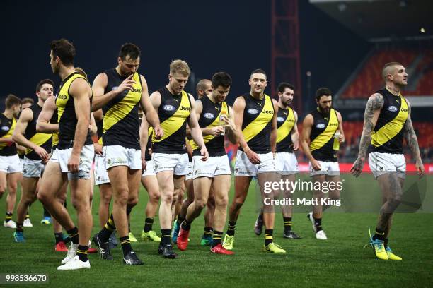 Trent Cotchin of the Tigers and team mates look dejected as they leave the pitch during the round 17 AFL match between the Greater Western Sydney...