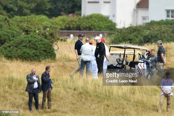 President Donald Trump and son Eric Trump play golf at Trump Turnberry Luxury Collection Resort during the President's first official visit to the...
