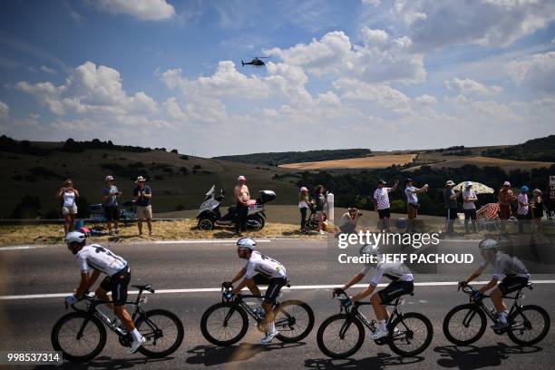 Spectators cheer as Italy's Gianni Moscon, Spain's Jonathan Castroviejo, Great Britain's Luke Rowe and Great Britain's Geraint Thomas ride during the...