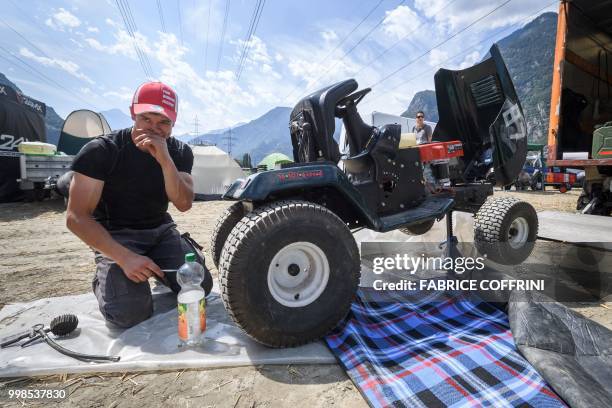 Team member prepares his lawn-mower as he takes part in the 5th edition of the motorised lawn mower race, on July 14, 2018 in Dorenaz, western...