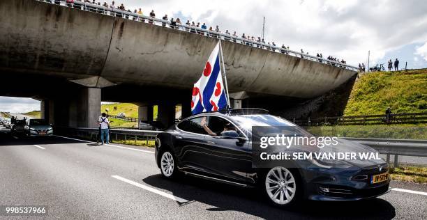 Sustainably fuelled vehicles pass under an aqueduct as they travel on the N31 highway near Leeuwarden on July 14 which has been specially closed for...