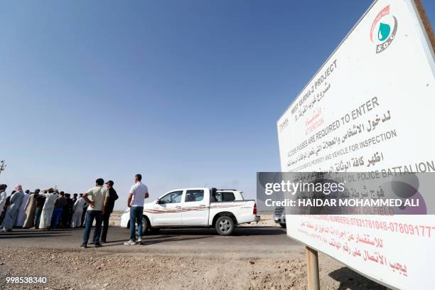 Iraqi protesters demonstrate against unemployment in front of oil fields in al-Qurnah, some 100 kilometers north of Basra, southern Iraq, on July 14,...